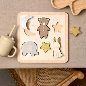 Wooden puzzle with animal shapes on a beige surface