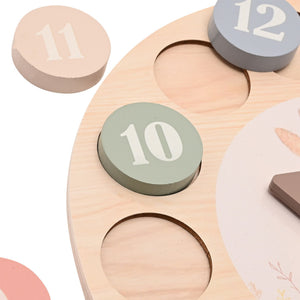 Close-up of number 10, 11 and 12 discs and recessed spaces on wooden learning clock