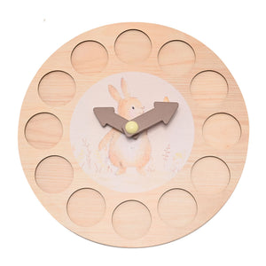 Wooden rabbit clock with all number discs removed showing twelve circular recesses