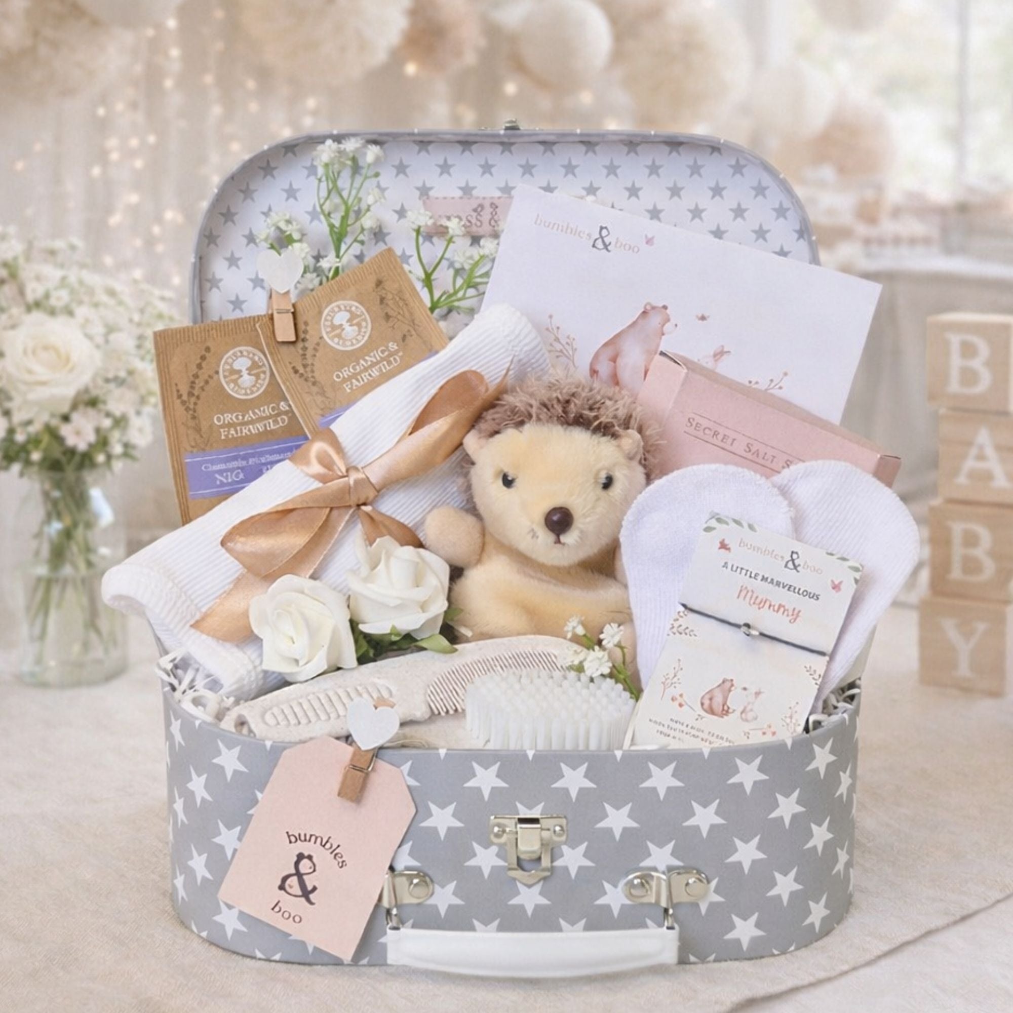 Presents for a baby shower celebration with relaxation salts and tea for the mum to be.