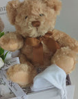 Unisex hamper gifts with teddy bear, muslin wrap, baby booties and hat.
