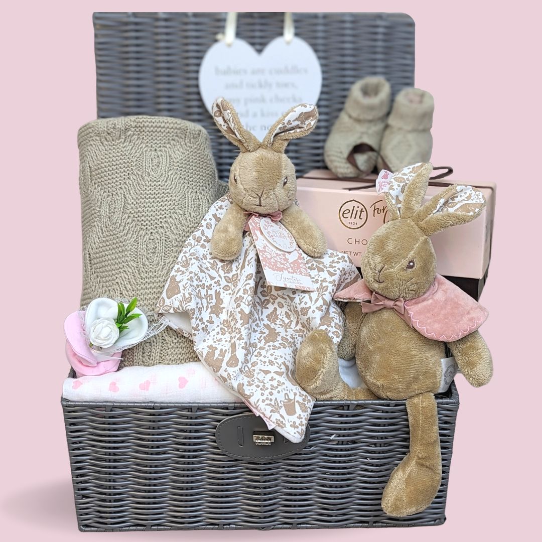 Baby Girl gifts in a hamper basket with a Beatrix Potter Flopsy Bunny Theme, pink and brown colour scheme.
