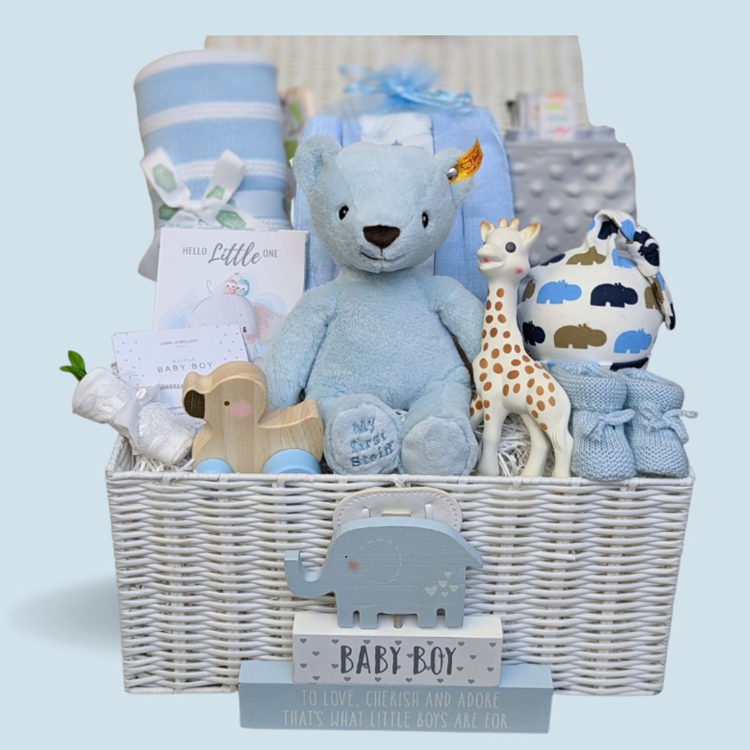 Baby boy hamper basket with teddy, blanket, toys, sophie la giraffe, baby hat and silver bracelet.