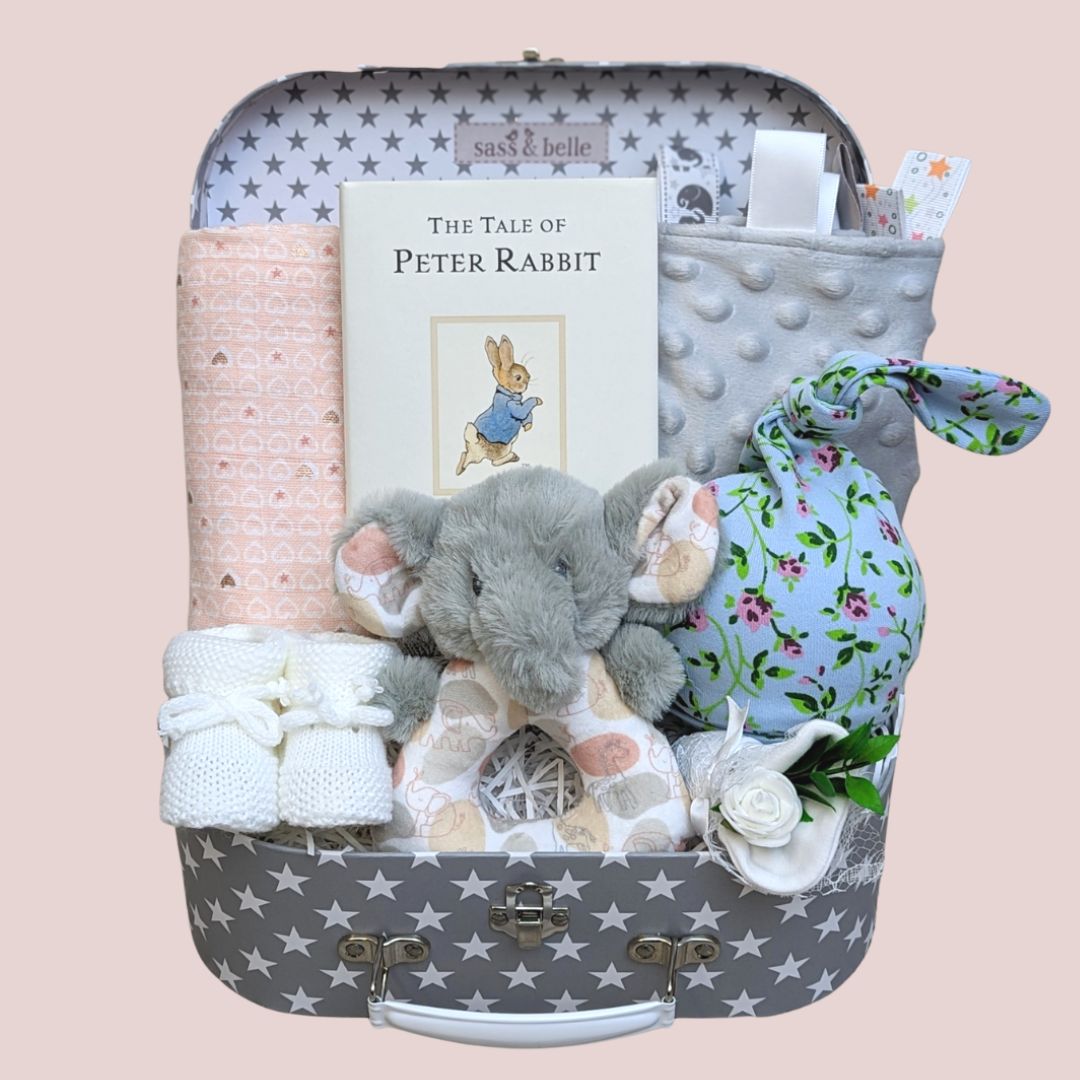 Baby girl gift box with peter rabbit book, muslin wrap, baby booties, taggie blanket and baby hat.