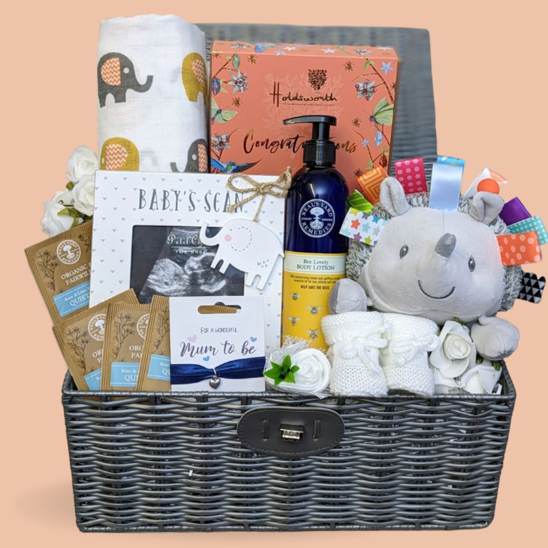 Baby shower gifts hamper with chocolates, baby scan frame, body lotion and hedgehog soft toy for baby.