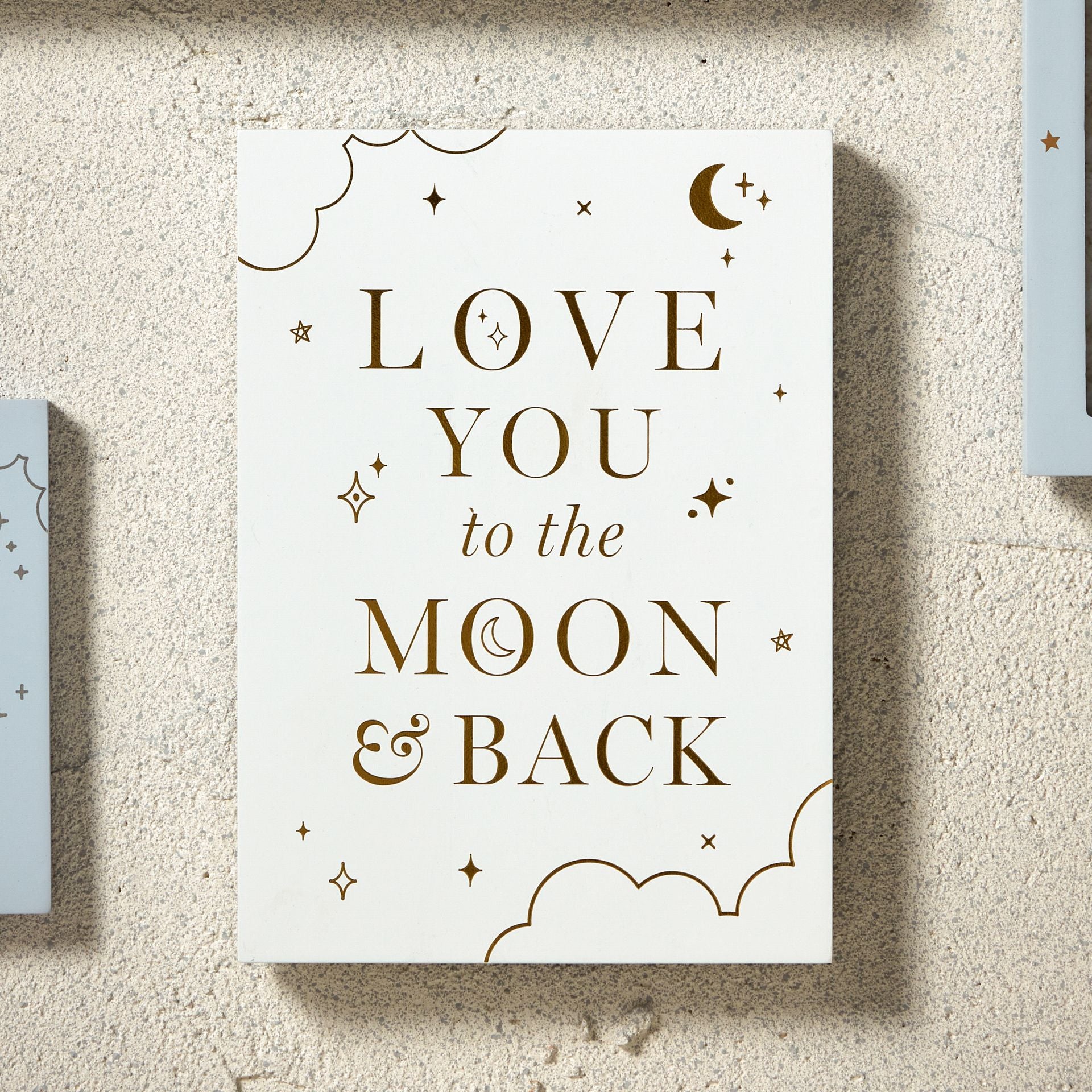 Light grey matt finished free standing nursery plaque with Love You To The Moon and Back in gold embossed writing