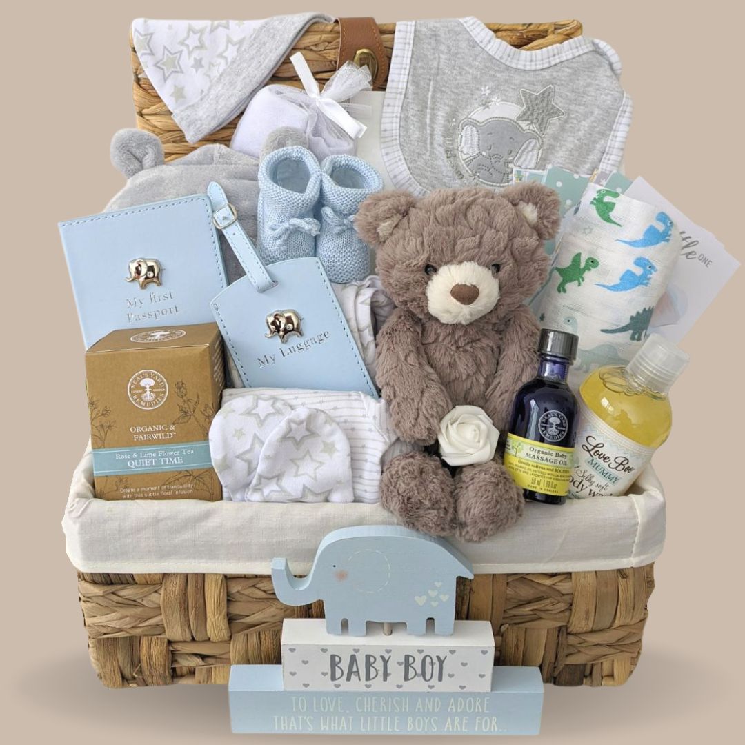 Baby boy hamper basket with clothing set, teddy bear, skincare, bath robe and nursery plaque.