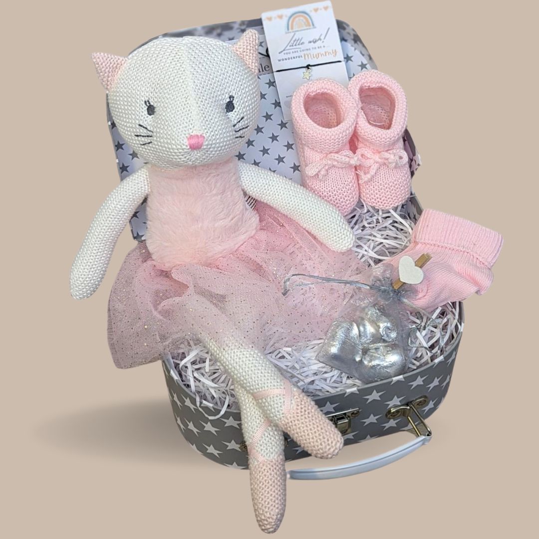 Baby girl hamper trunk with knitted ballerina, socks, booties, chocolates and bracelet.
