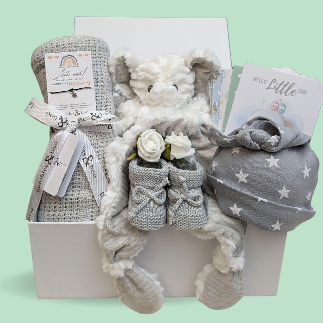 new baby gifts box in white and grey unisex design wtih blanket, hat, elephant and milestone cards.