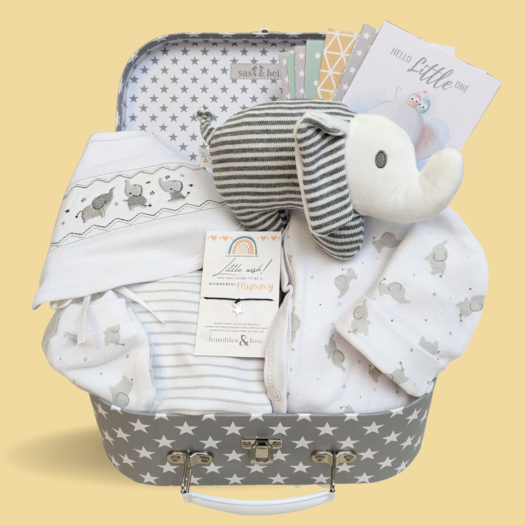 baby shower hamper gifts with white clothing set, & stripy elephant baby rattle.