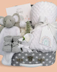 Baby shower hamper gifts including white blanket and elephant comforter in a grey stars hamper.