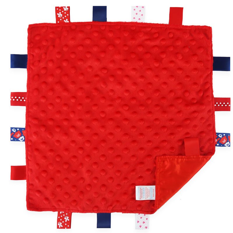 Square red comforter tagged blanket with ribbon tangoes around the edge in blue and red.
