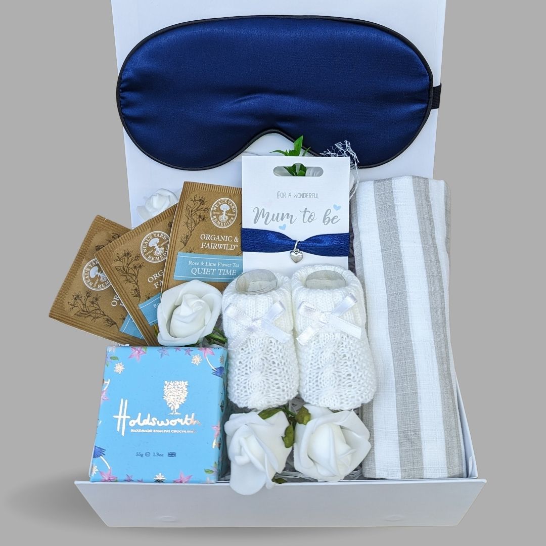 Pregnancy hamper with treats for Mum. Includes bracelet for Mum, baby booties, chocolates and skincare.