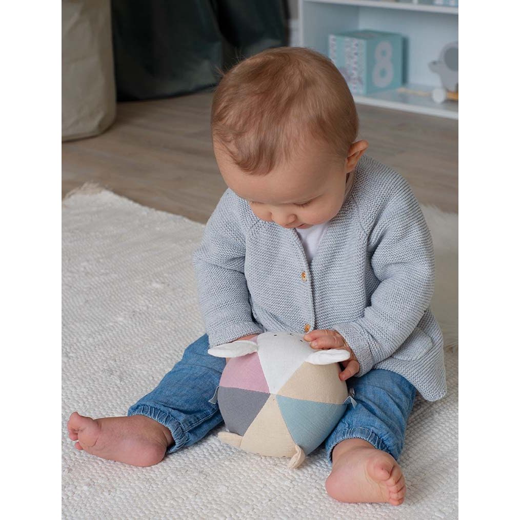 A soft cloth ball in neutral tones.  With a teddy and bunny design, perfect gift for a baby.