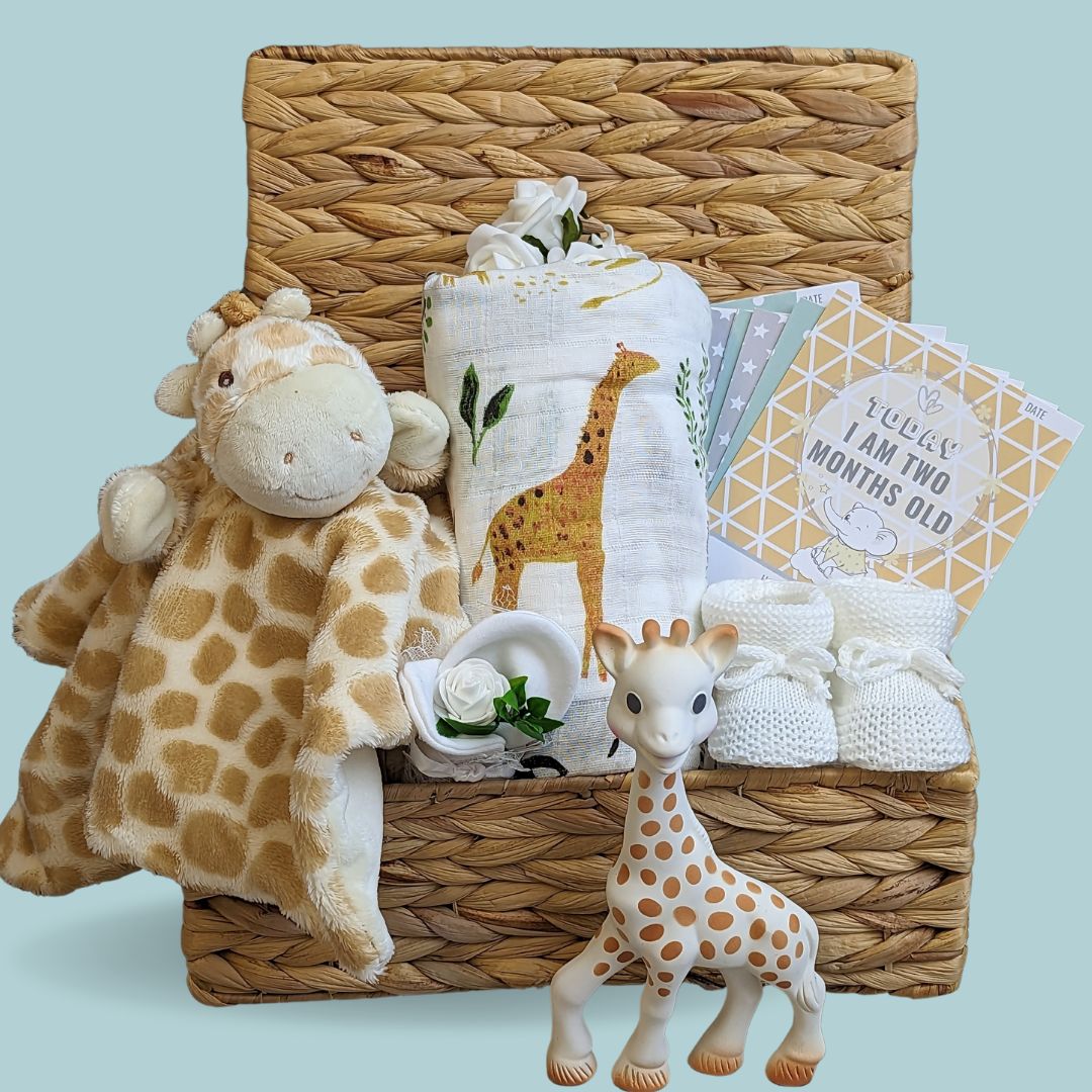 New baby gifts in a hamper basket with giraffe theme.