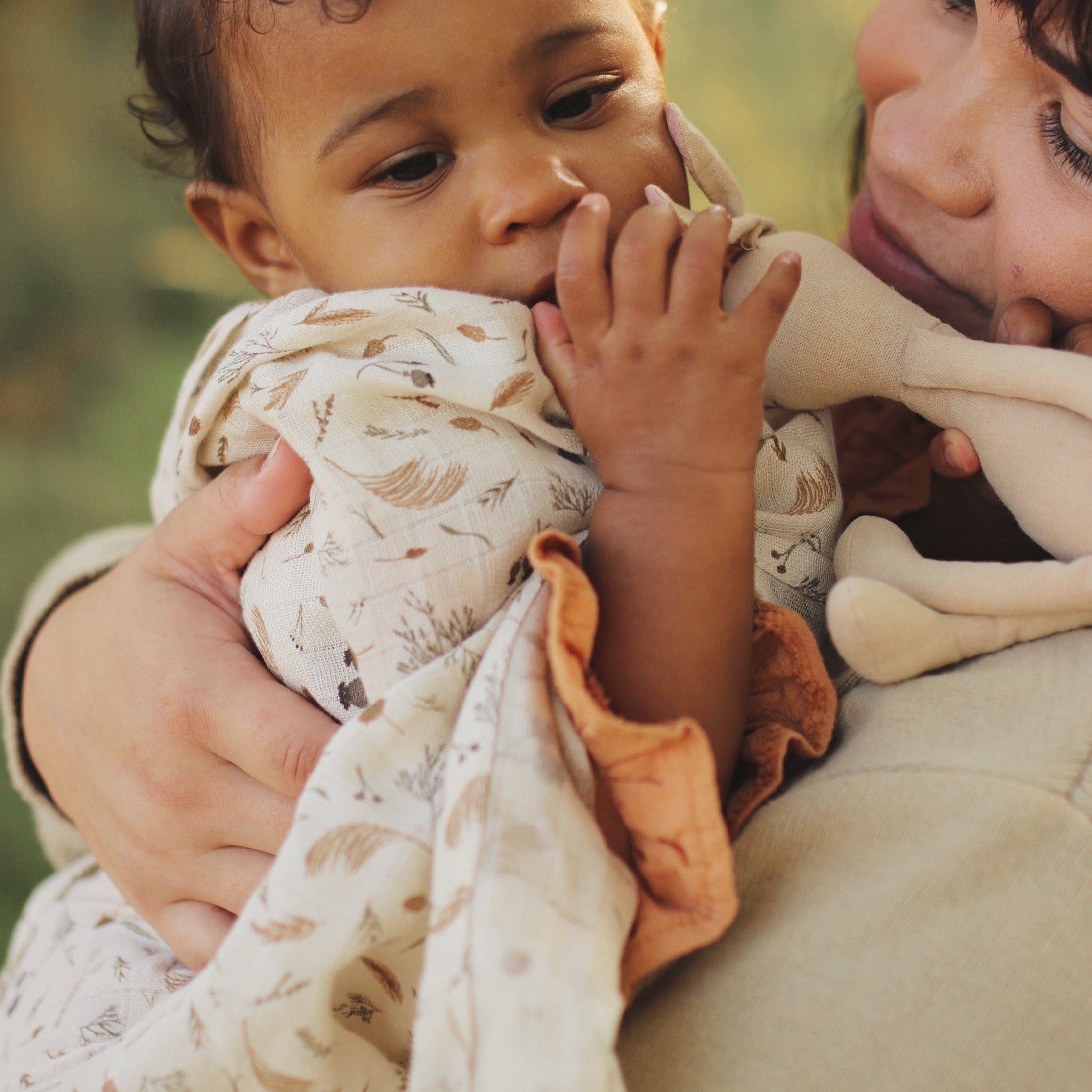Baby wrapped in a muslin cloth.