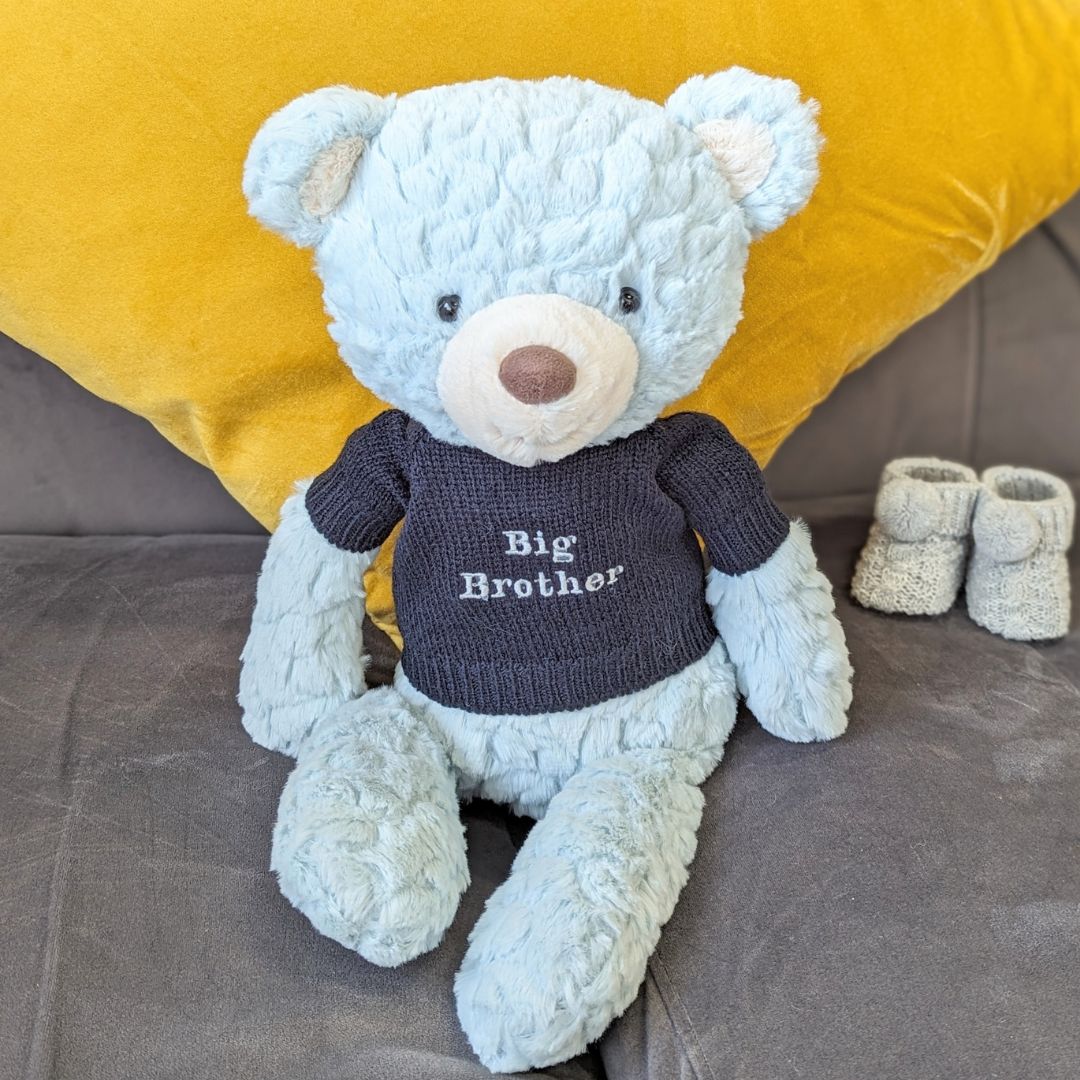 Teddy wearing a big brother t-shirt.