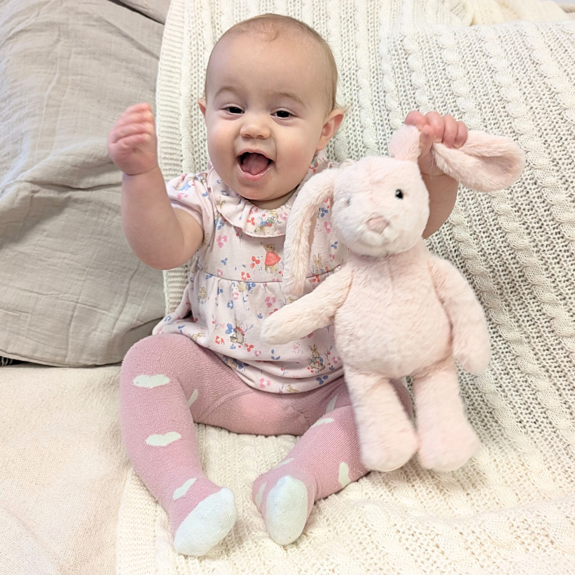 Baby with a toy rabbit.