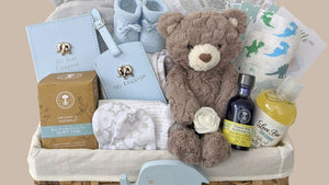 Baby boy hamper with presents packed in a basket.