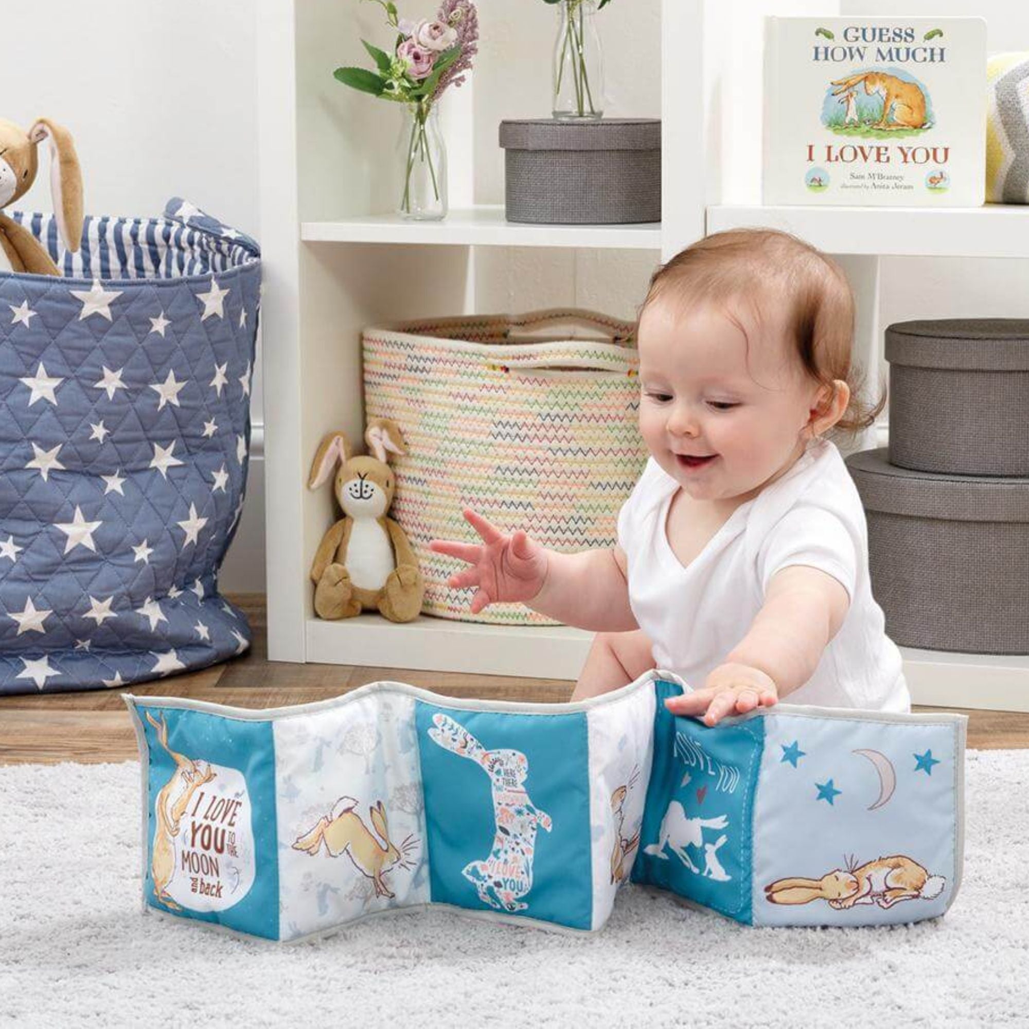 6 month old baby playing with a toy.
