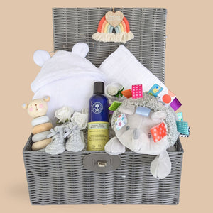 new baby gifts in a hamper basket.