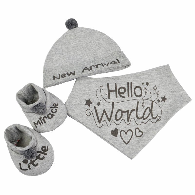 3 piece grey baby outfit with wording. Contains a &#39;New Arrival&#39; pom-pom hat, &#39;Hello World&#39; bib and &#39;Little Miracle&#39; pom-pom booties