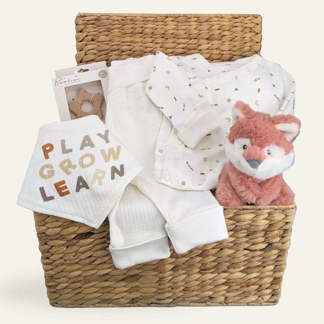 baby hamper basket with organic clothing and soft toy