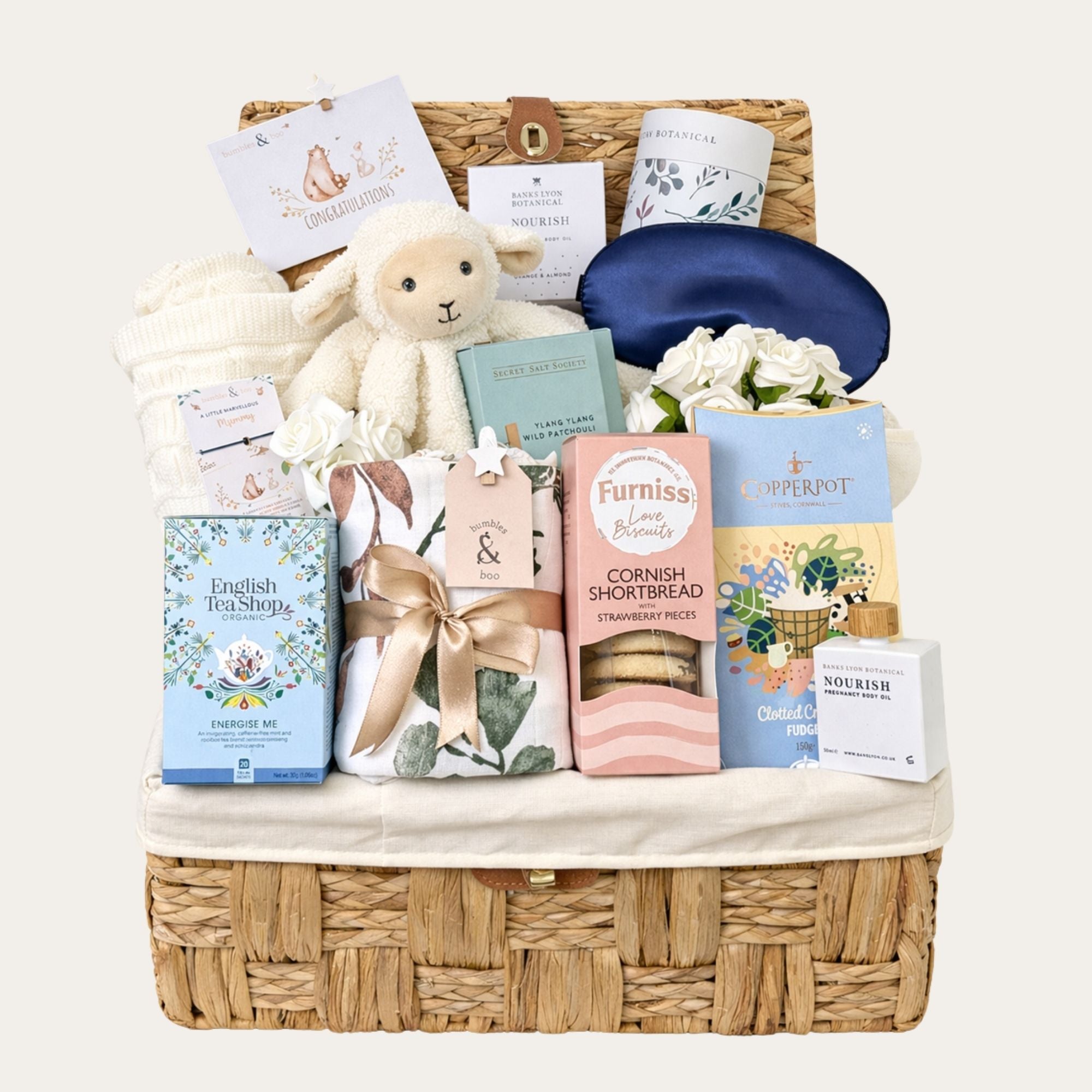 Mum to be gifts hamper presented in a large wicker basket with white lamb coft toy and sweet treats for mum to be from Bumbles and Boo. 
