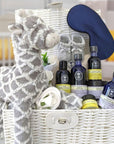 Pregnancy hamper basket with organic skincare, baby clothing, silk eye mask and giraffe soft toy.