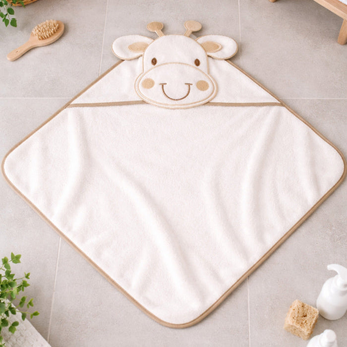 White giraffe hooded newborn baby towel laid flat on bathroom floor