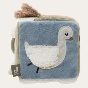 Children's soft book with a duck illustration on a blue background