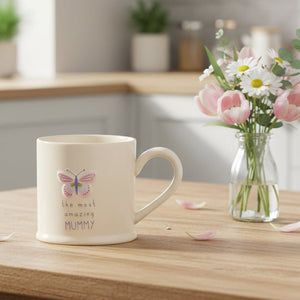 Amazing mummy mug with embossed pink butterfly design and the most amazing mummy wording on a cream white stoneware mug 