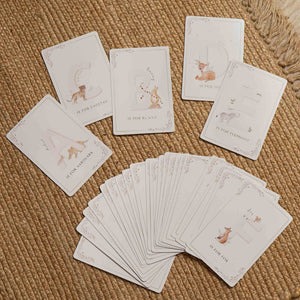 Animal alphabet cards A to E spread on a woven surface beside a fanned stack topped with the fox card.