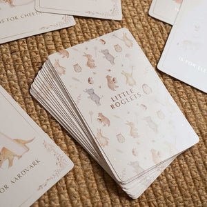 Close-up of the alphabet card backs with repeating animals and Little Roglets lettering.
