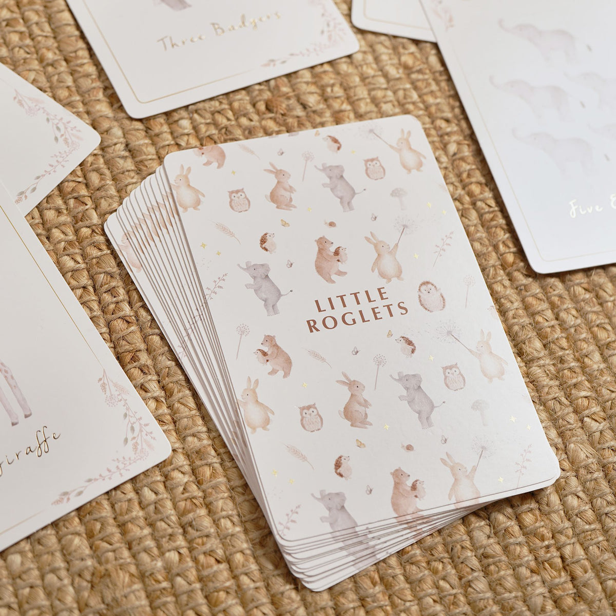 Close-up of the stacked number cards showing the illustrated animal pattern on their backs.