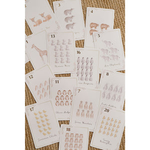 Assorted animal number cards on a woven background, with counting groups from across the set.