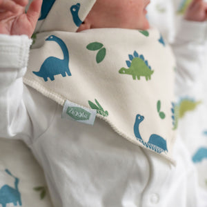 Cream bandana baby bib with dinosaur print