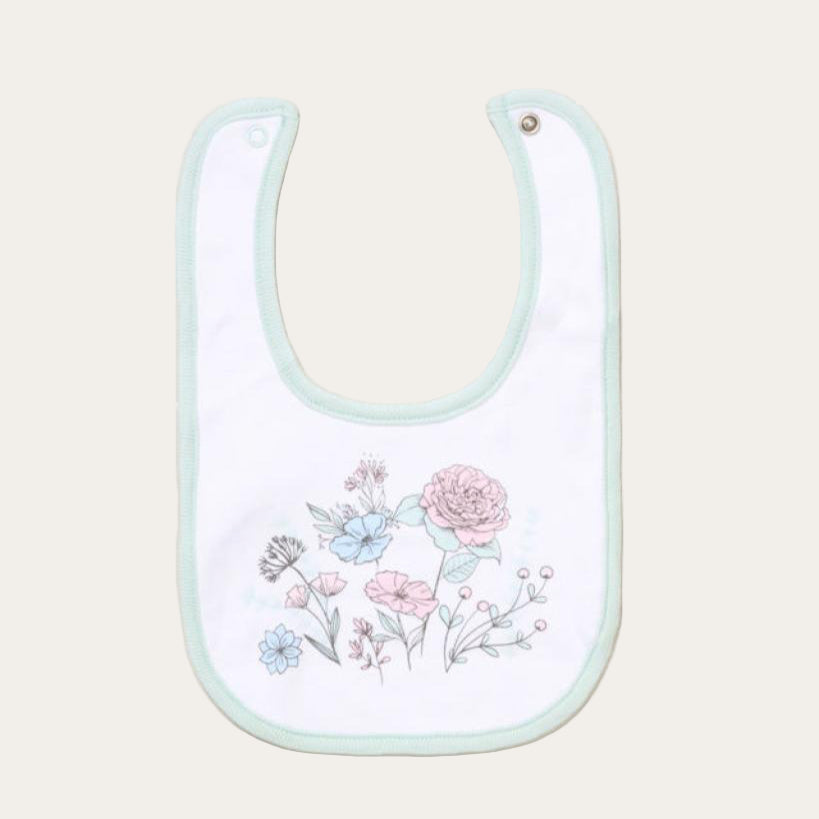 Baby bib with a green boarder and flowers in the center