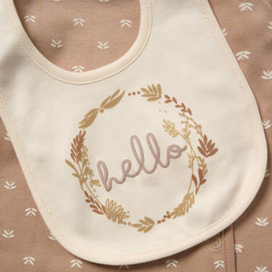 Cream bib with "hello" and leaf wreath print