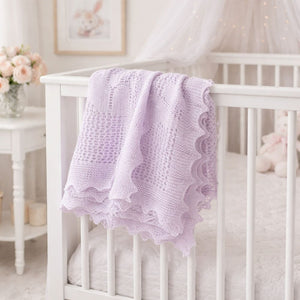 A lilac baby blanket with scalloped edges perfect for a new baby or christening
