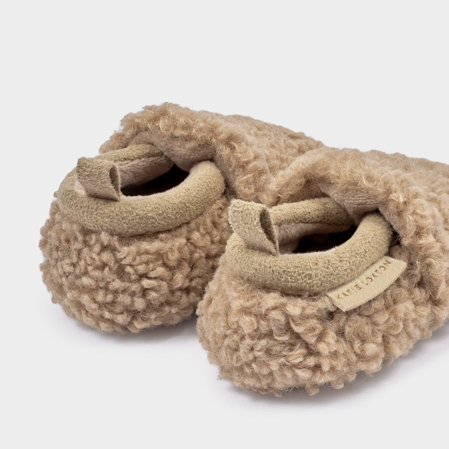 Close-up of tan Baby Borg Shoes with suedette trim