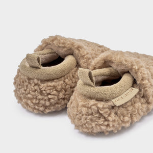 Close-up of tan Baby Borg Shoes with suedette trim