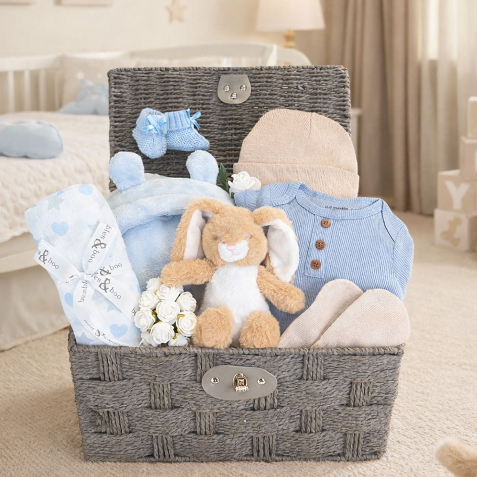 Bunny rabbit baby hamper in a grey rope gift hamper with baby clothing. 