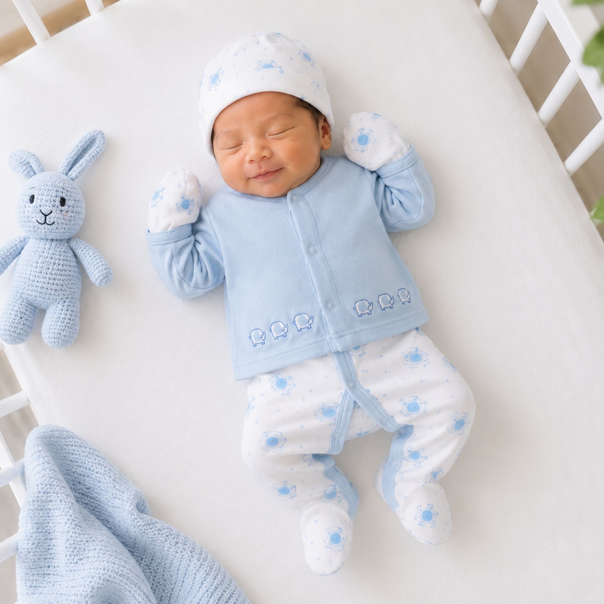 A six piece clothing set with an elephant theme for baby boy in blue and white
