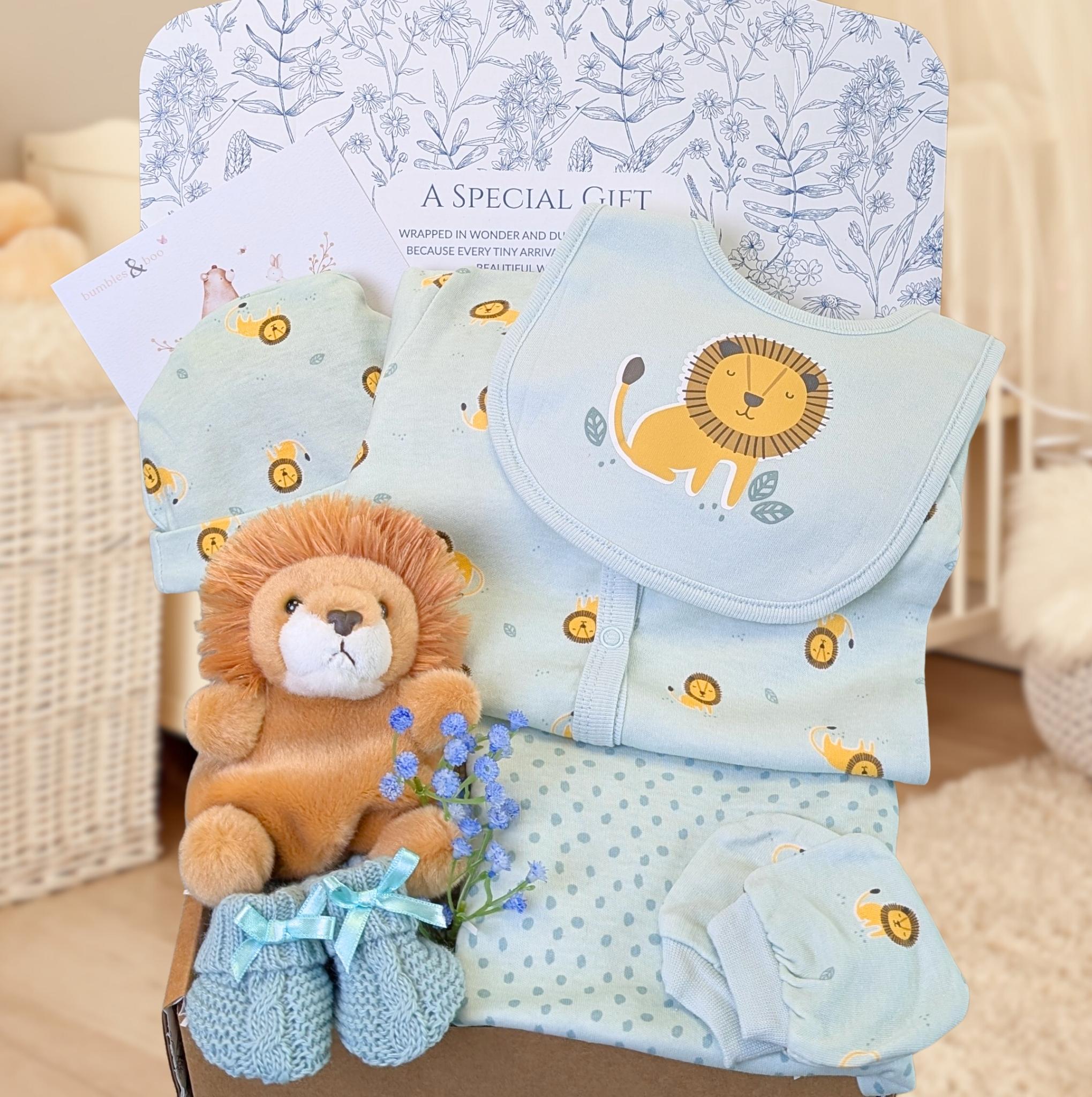 New baby boy gift box with a blue lion patterened clothes set and a lion soft toy. 