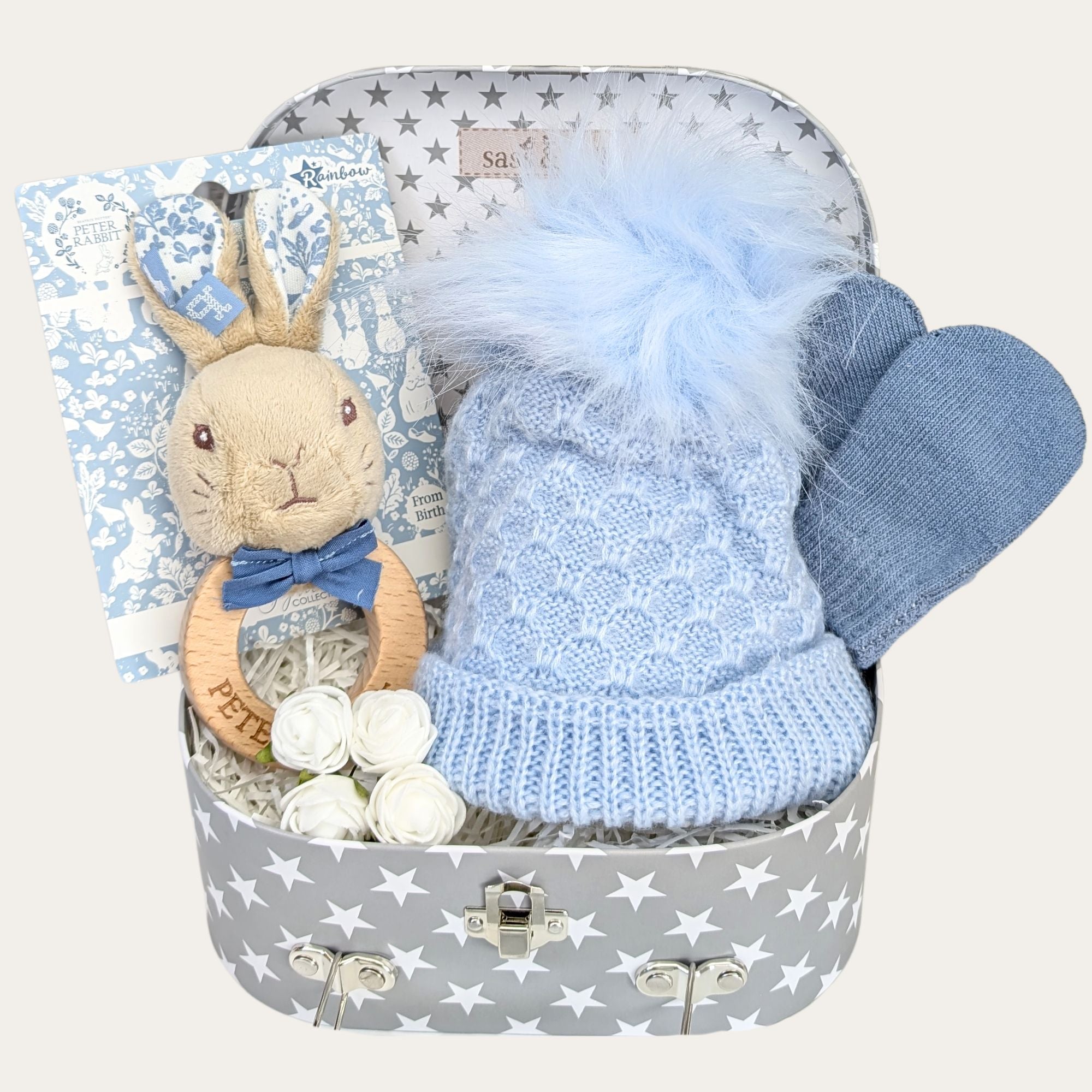 Baby boy hamper with gifts including peter rabbit toy and blue baby accessories by Bumbles and Boo.