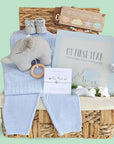 Beautiful basket for a new baby boy with cable knit clothing set, musical pram toy elephant, baby blanket, baby boy journal and a silver bracelet for a new mummy.