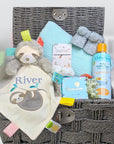 baby boy gifts basket with sloth blankie, mint green blanket, baby wash and treat for the parents.