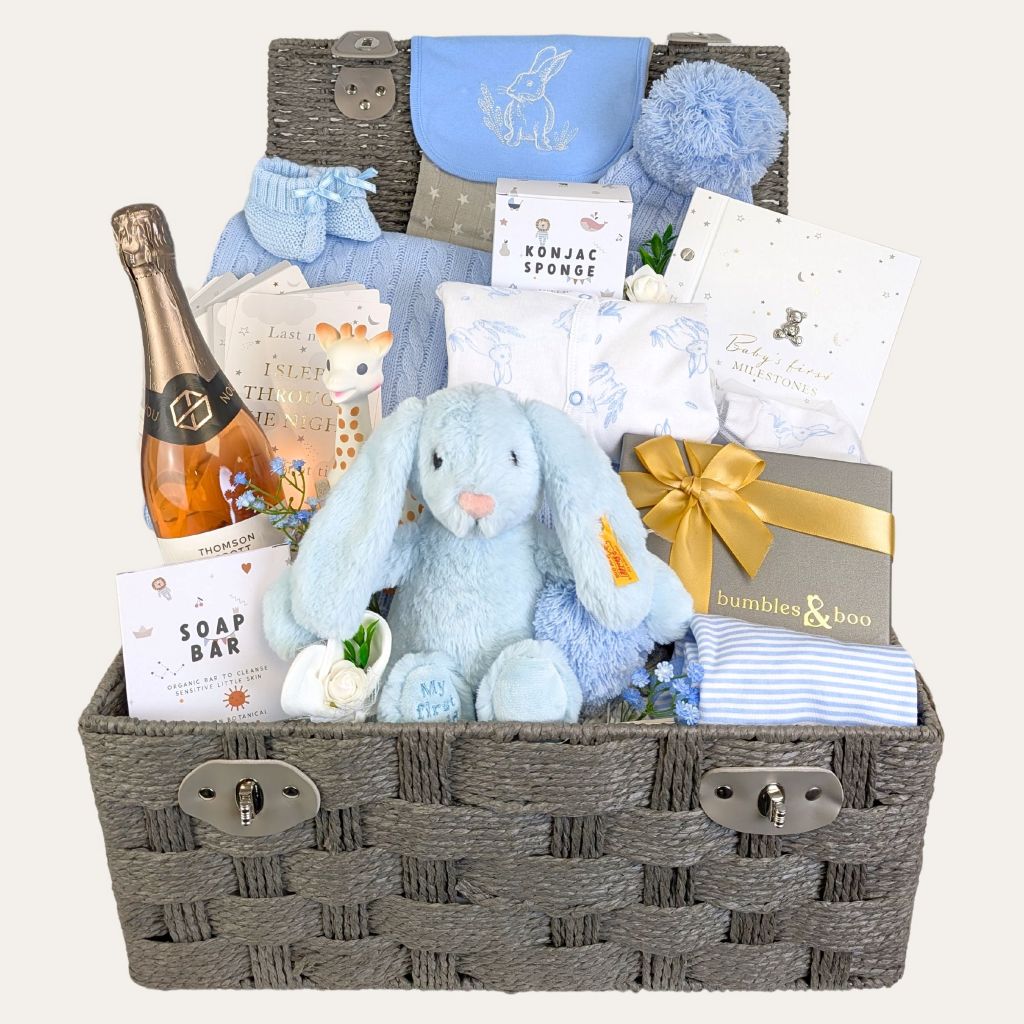 Baby boy gifts hamper filled with luxury presents. Includes blue clothes, bunny toy and treats for parents.