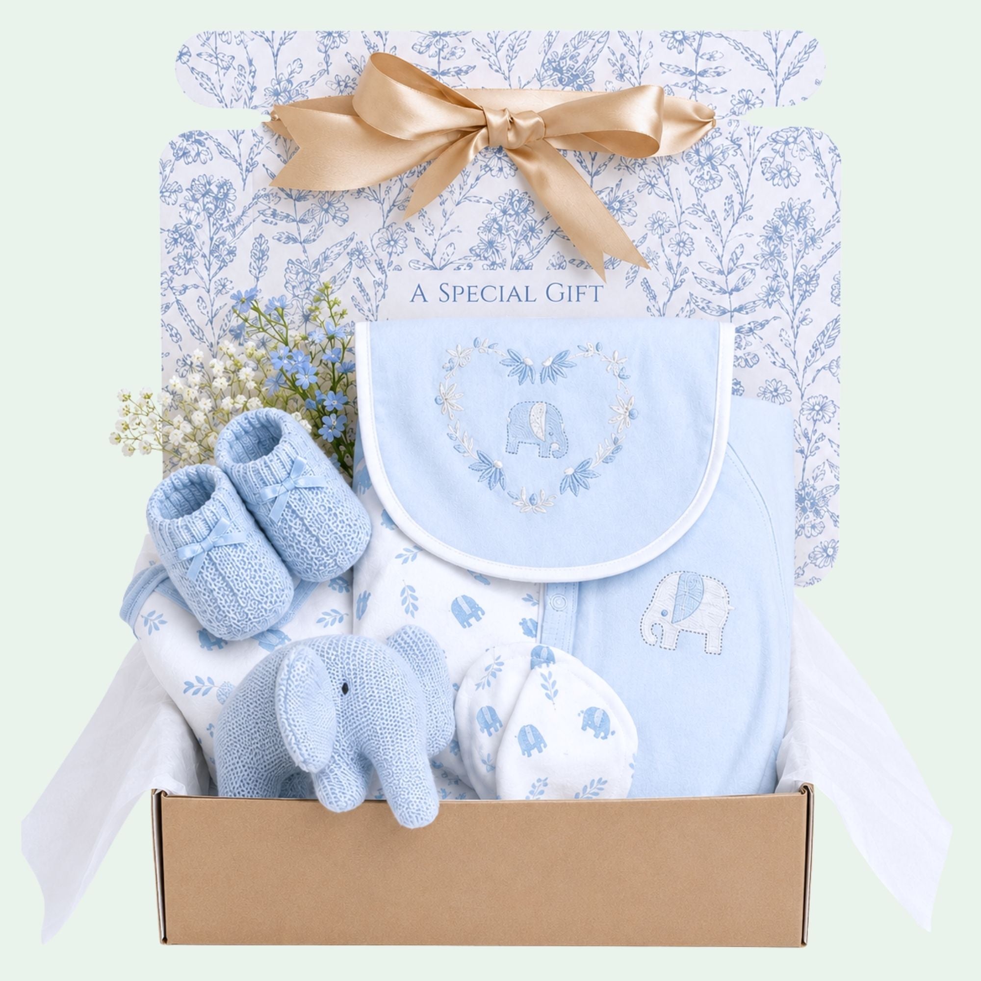 Baby boy gifts hamper with an organic elephant soft toy and baby clothing.